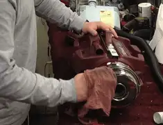 Vacuum repair technician cleaning and servicing a vacuum motor in Denver, CO